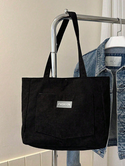 Corduroy tote bag vist med laptop og bøger indeni