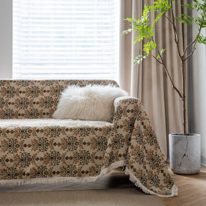 Sofabetræk med jacquardvævet blomstermønster og kvastekanter – beige