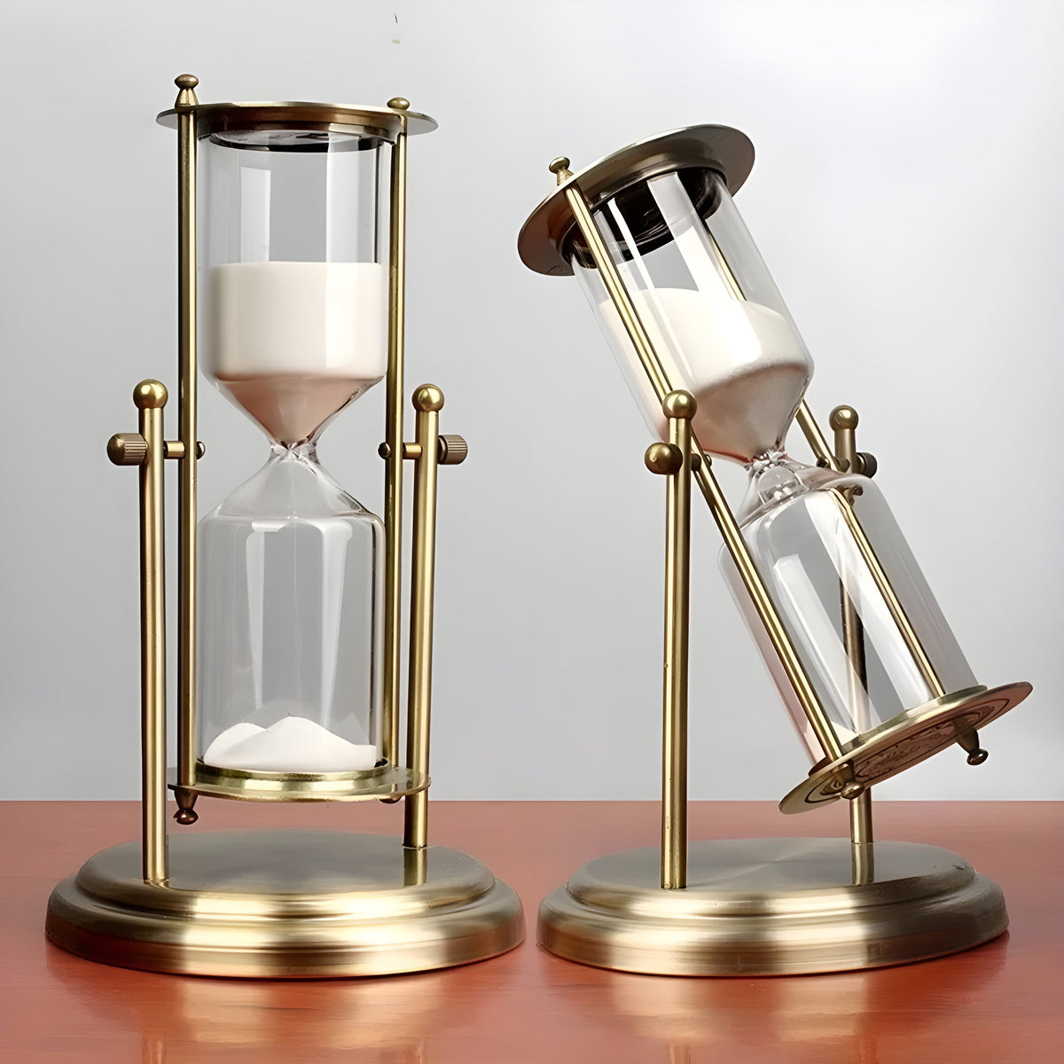 Elegant timeglas med sandfyldt glaskrop og messingramme i guld